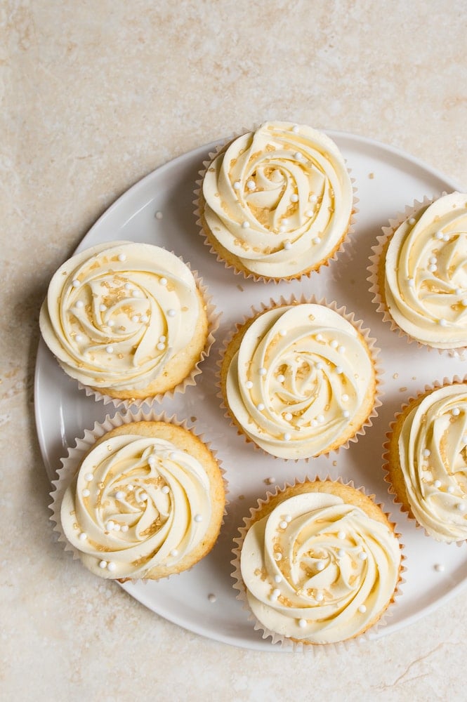 White wedding cake cupcakes made with almond extract and topped with buttercream roses that are so easy! Small batch cupcake recipe for your anniversary.