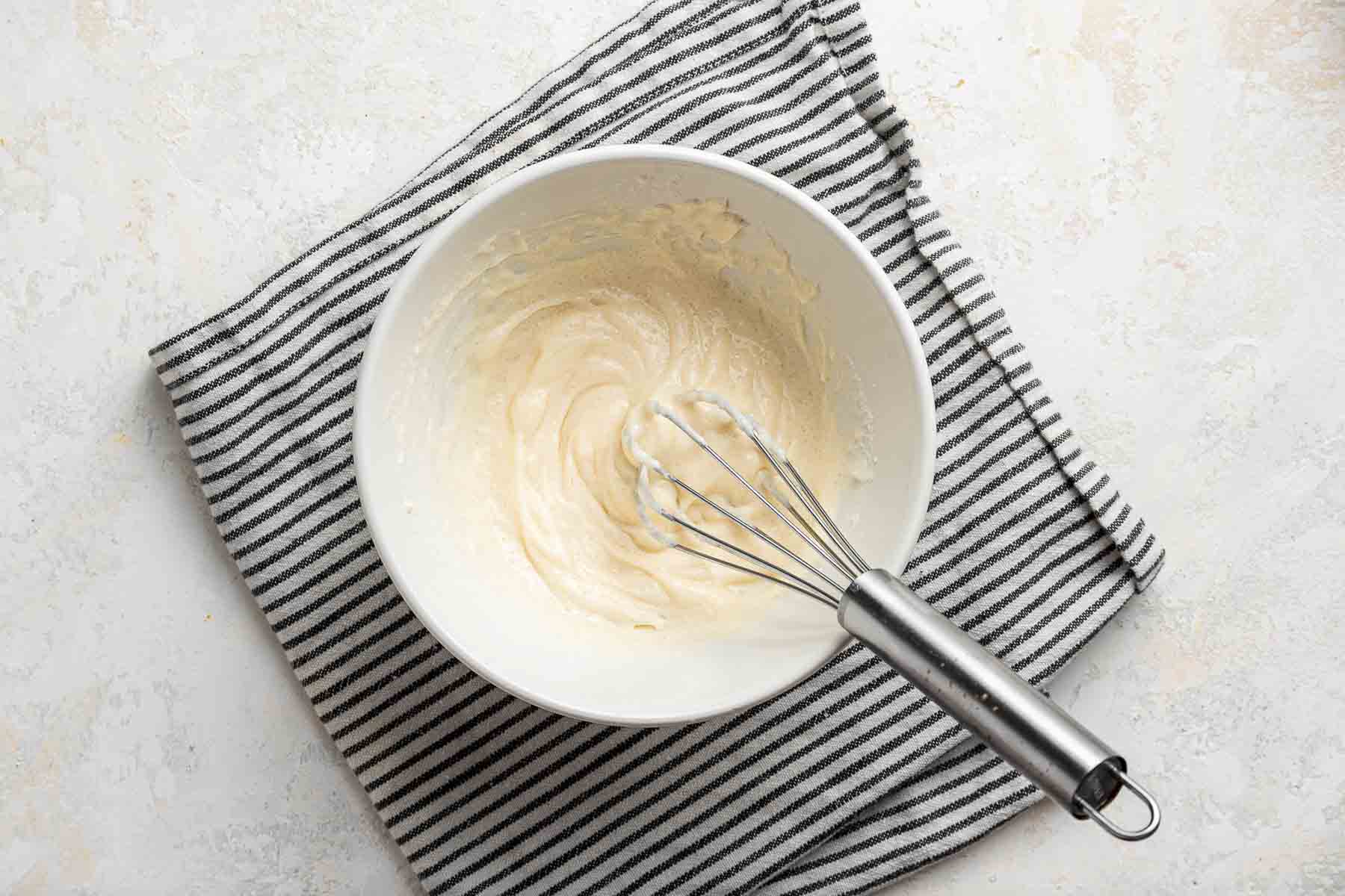 Cheesecake batter for swirling into cheesecake brownie bites.