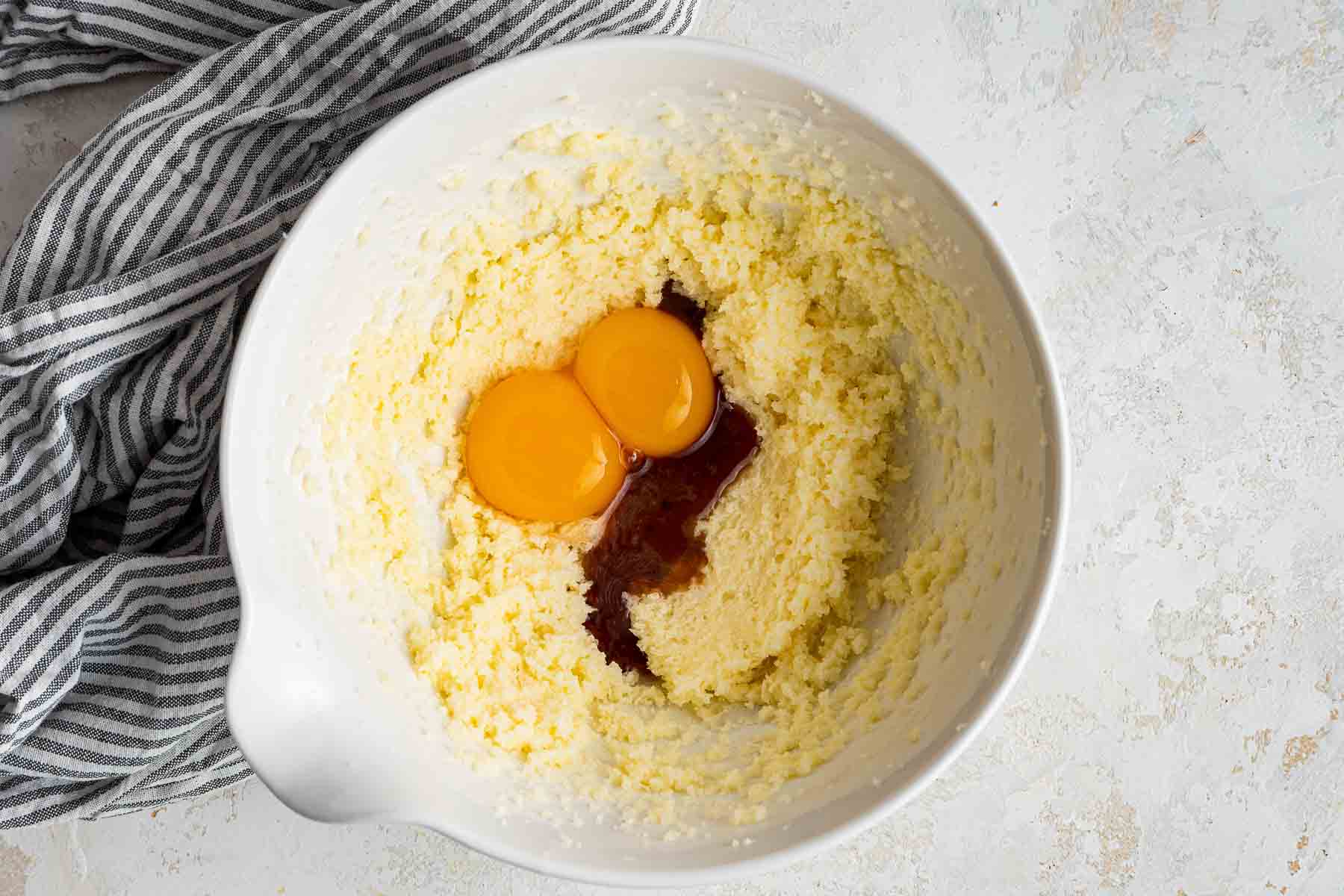Egg yolks and vanilla on top of yellow batter.