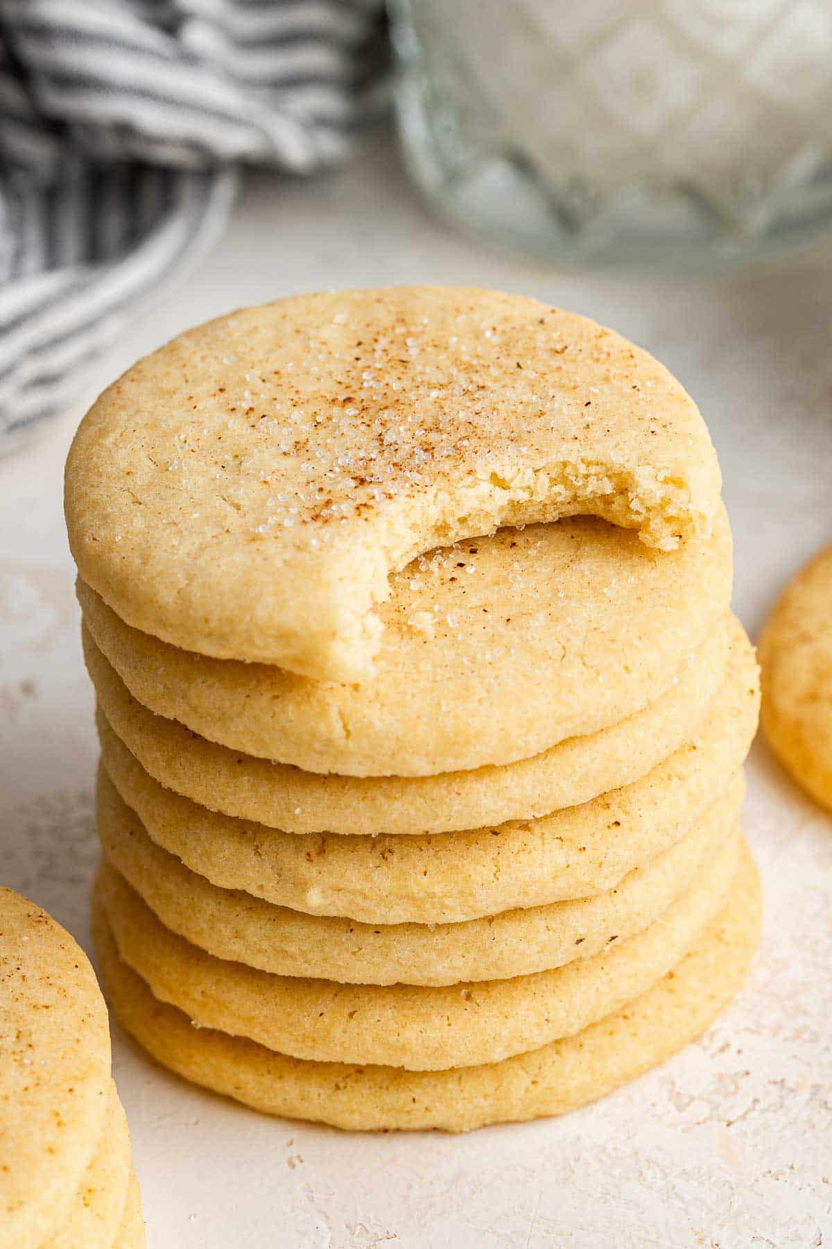 Stack of Southern tea cakes with top cookie missing a bite.
