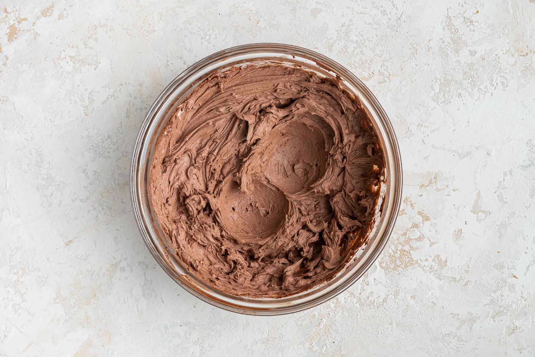Freshly made chocolate whipped cream in round bowl.