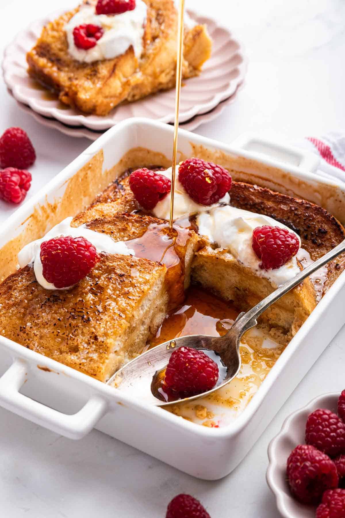 Pan of creme brulee French toast with one piece removed.