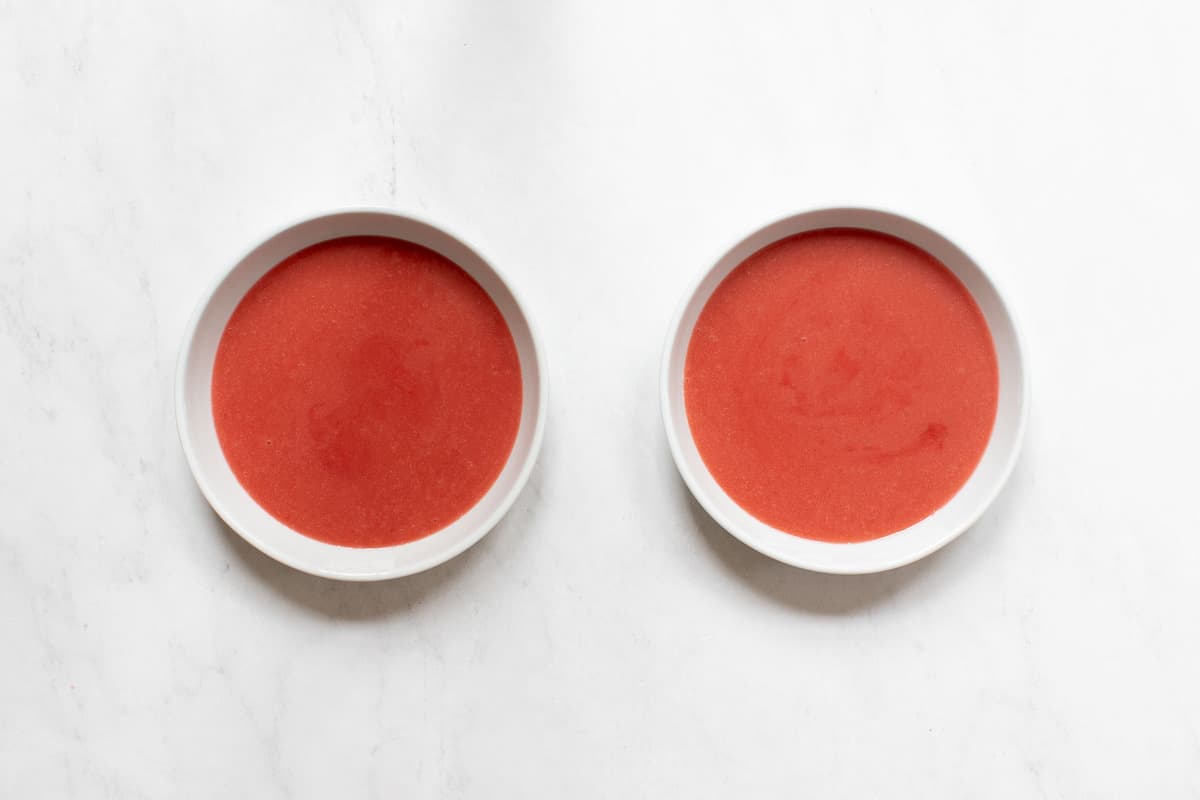 Side by side bowls of strawberry pudding.