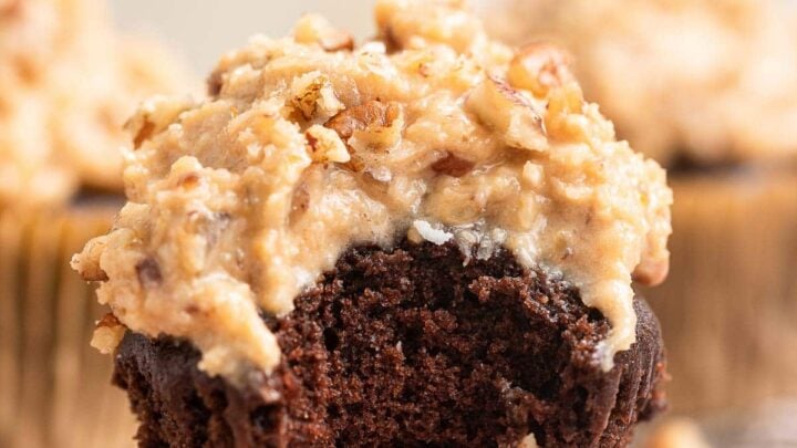 Single chocolate cupcake with creamy brown frosting with pecans.