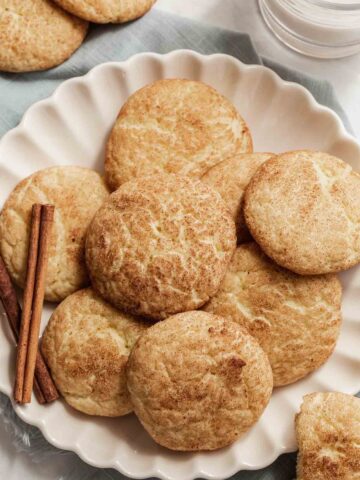 Overhead shot of plate of small batch snickerdoodles with cinnamon stick on side.