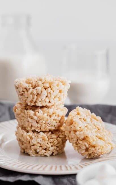 four rice krispies cups stacked on a plate