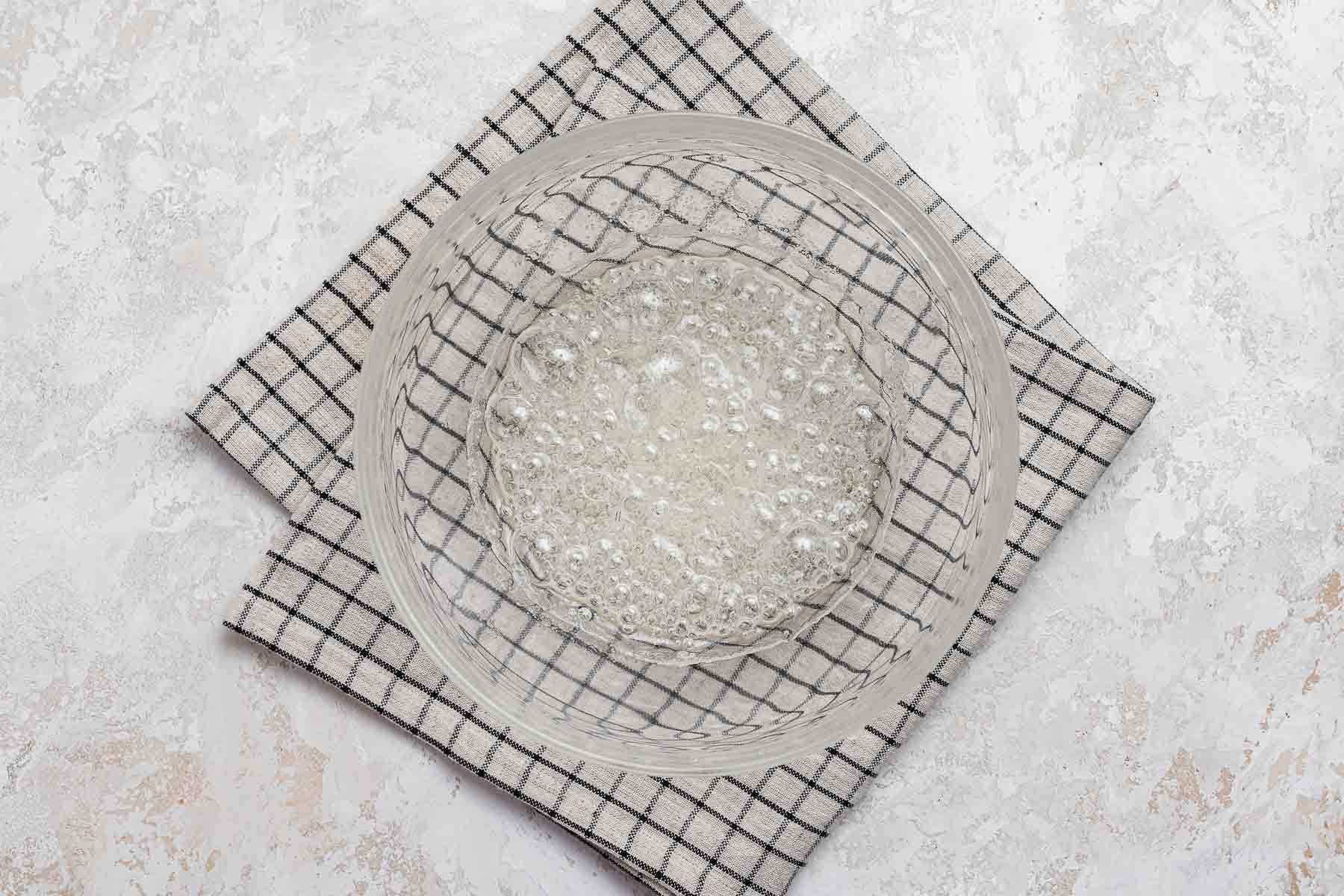 Boiling sugar in clear glass bowl.
