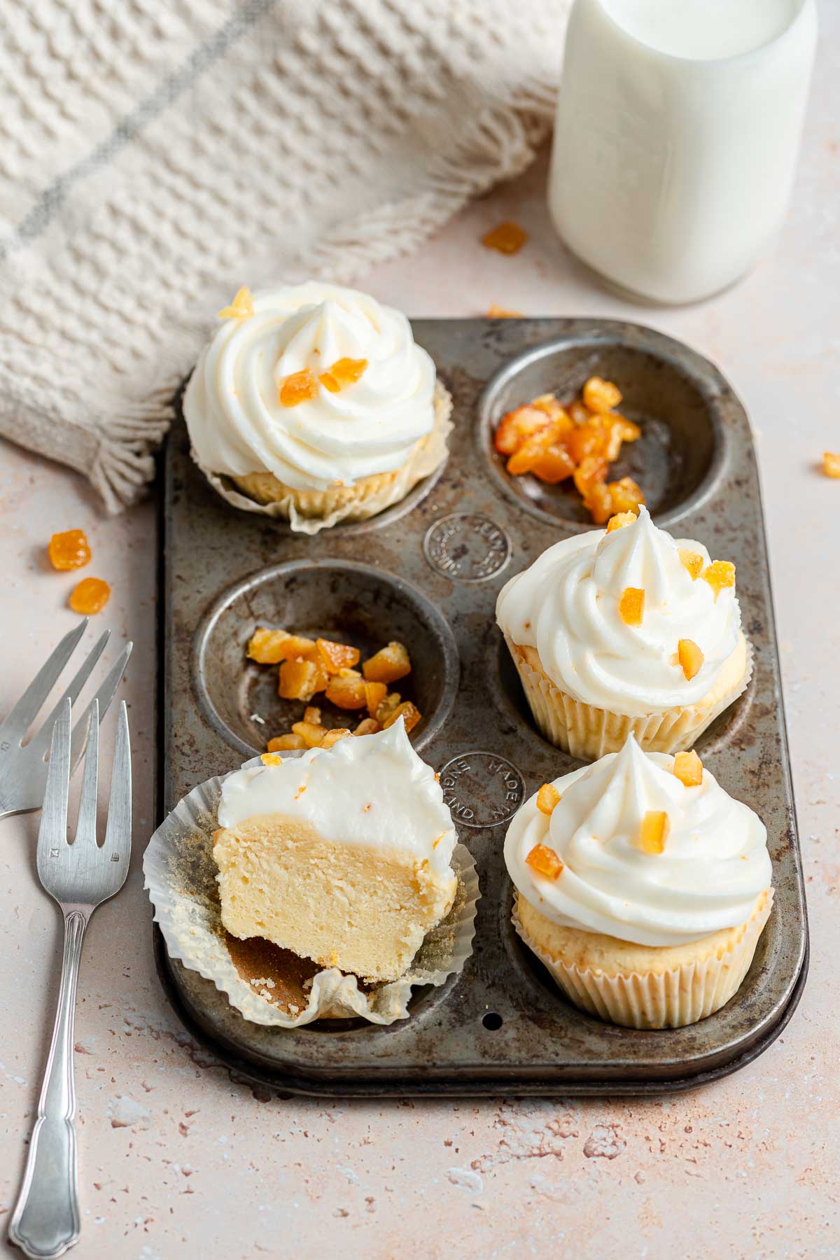 Four ricotta pound cake cupcakes in a muffin pan.