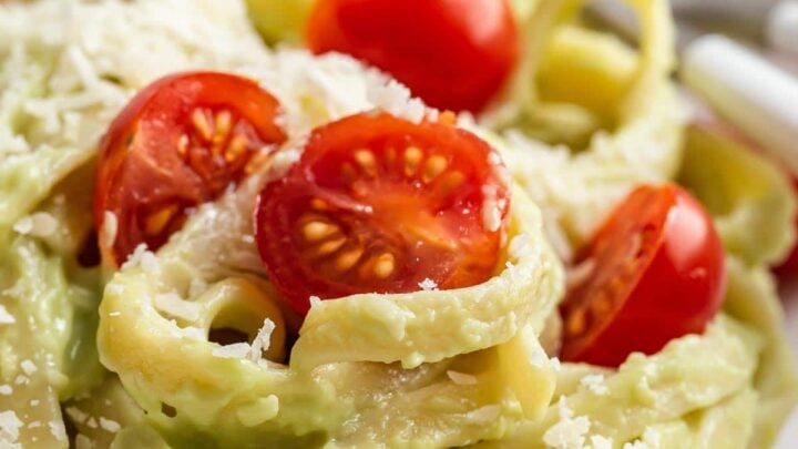 Avocado sauce on noodles with cherry tomatoes.