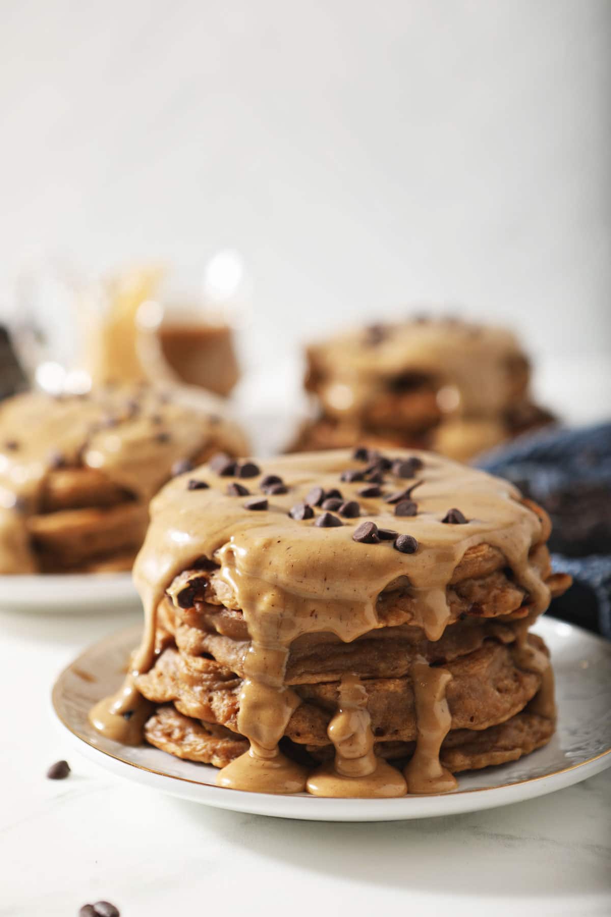 Stack of coffee pancakes with mini chocolate chips on top.