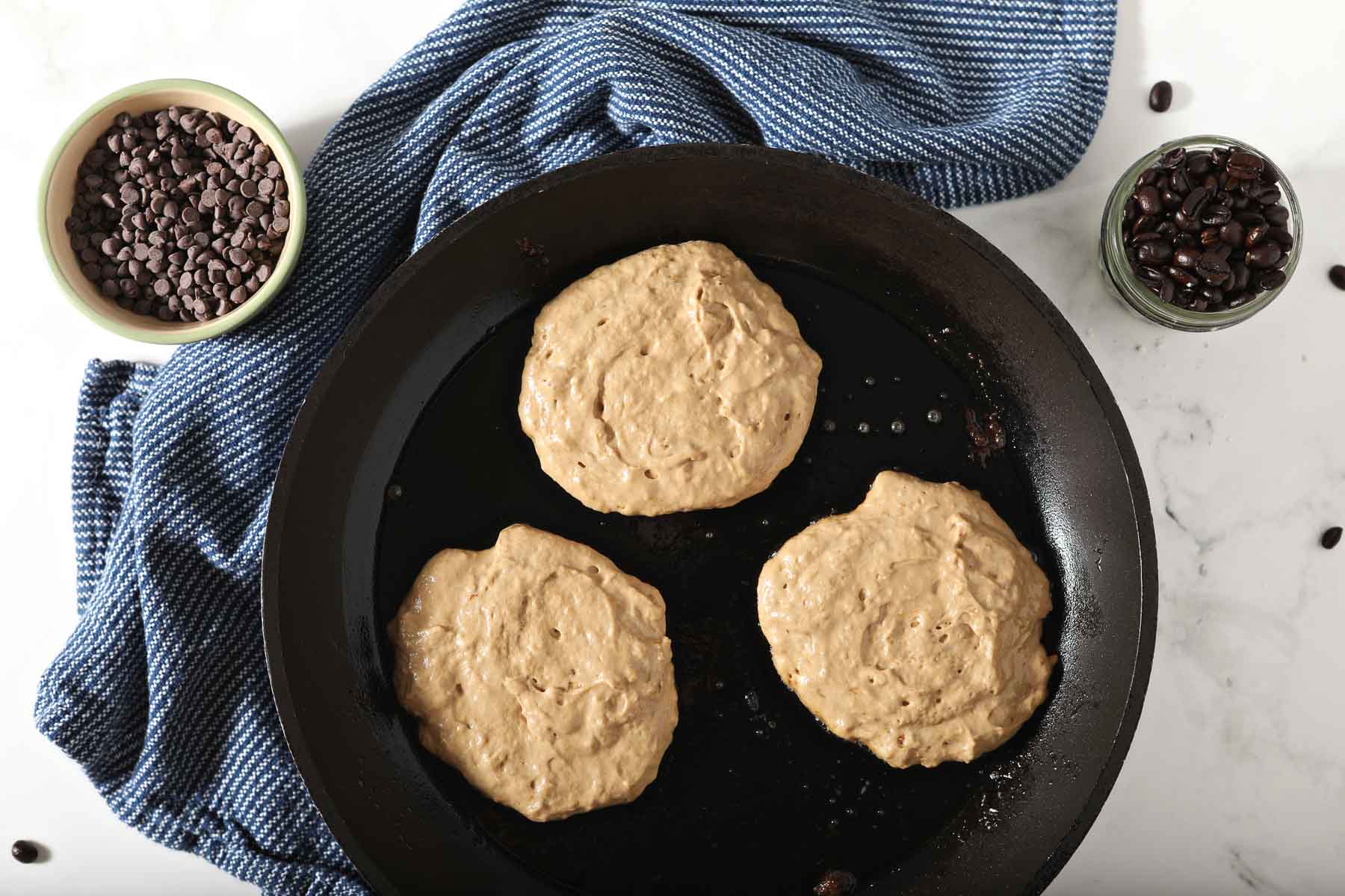 Three pancakes in a skillet.