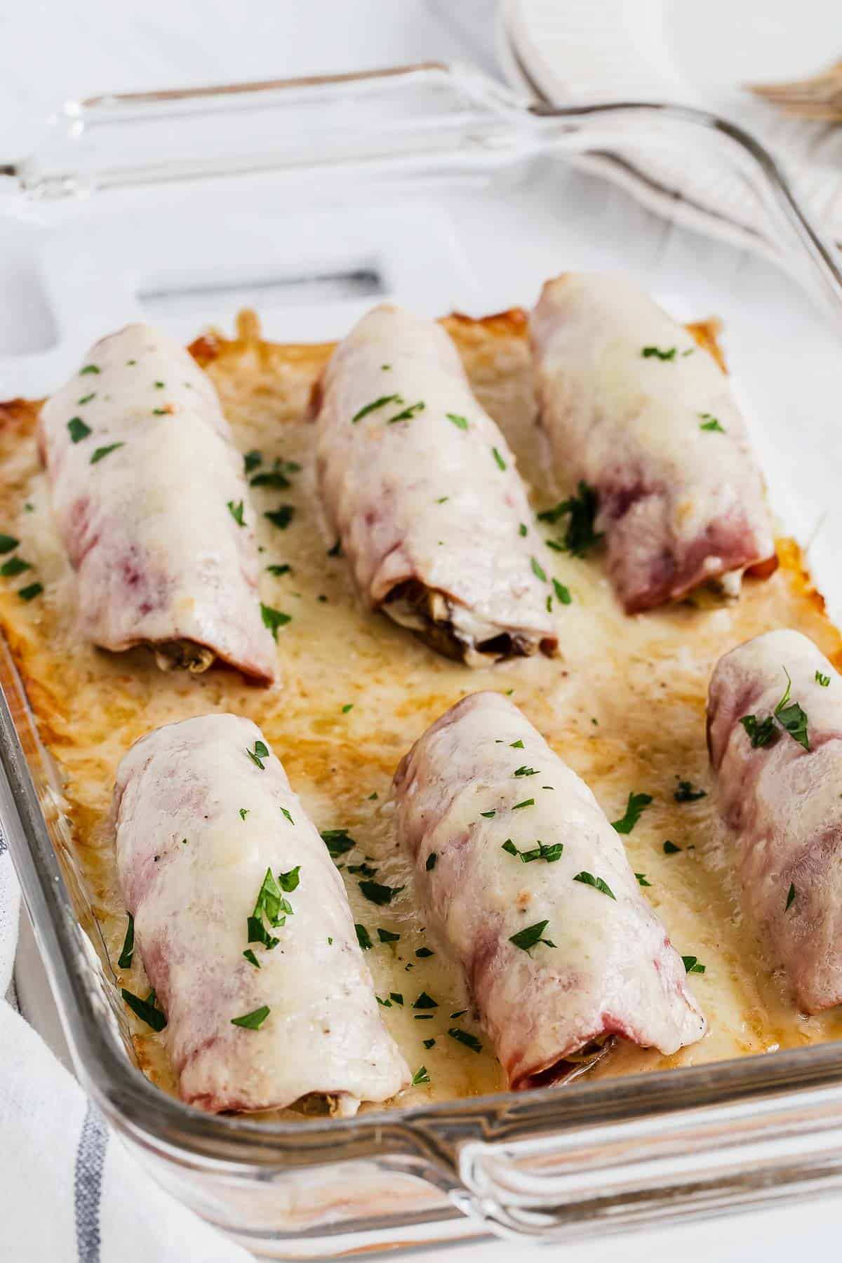 Baked endive in cheese sauce in baking pan.