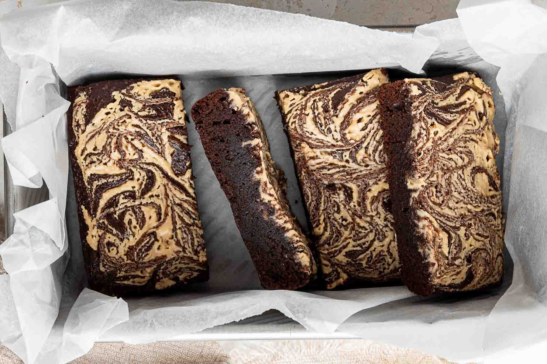 Baked brownies with tahini swirl on top surface.