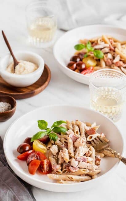 two bowls with chicken and creamy pasta