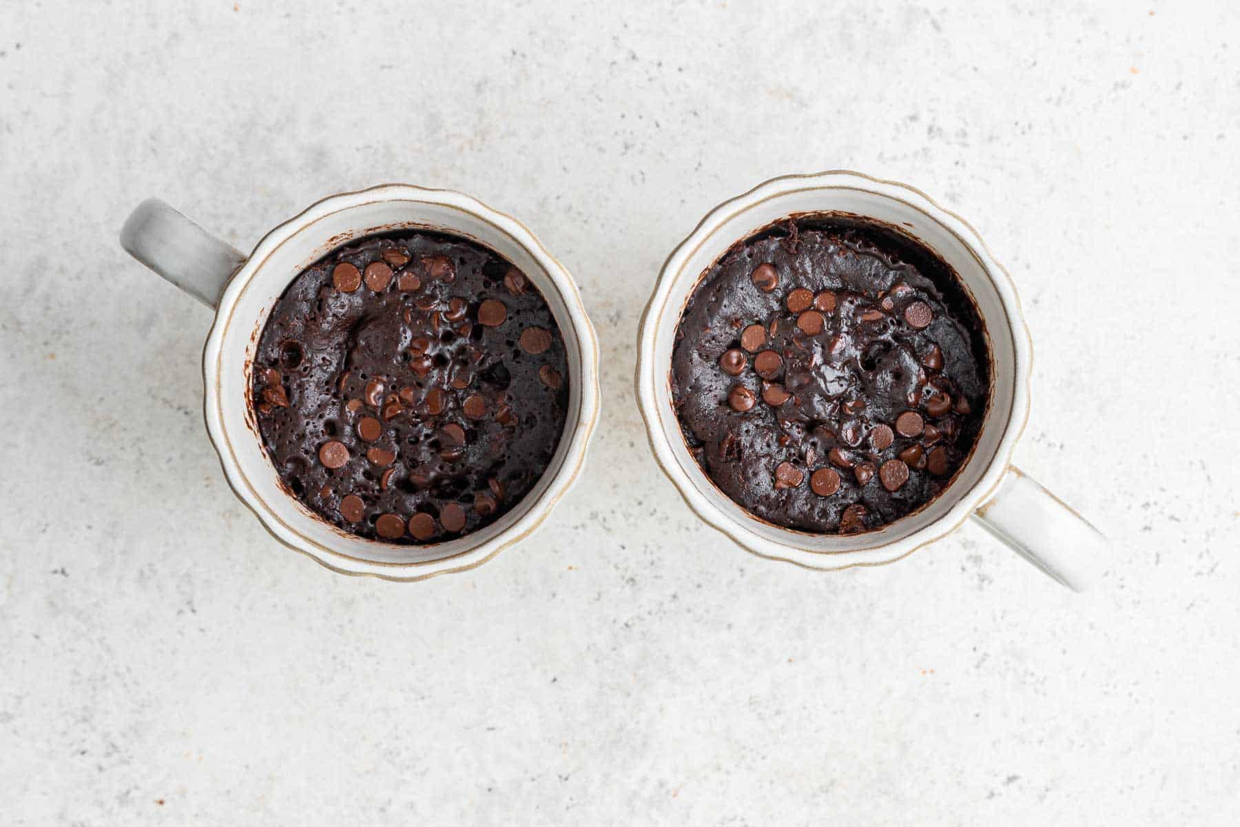 Chocolate mug cakes right out of the microwave in 2 mugs.