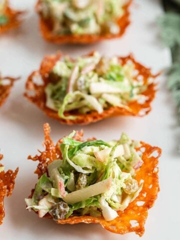 Brussels sprout slaw scooped into cheese cups.