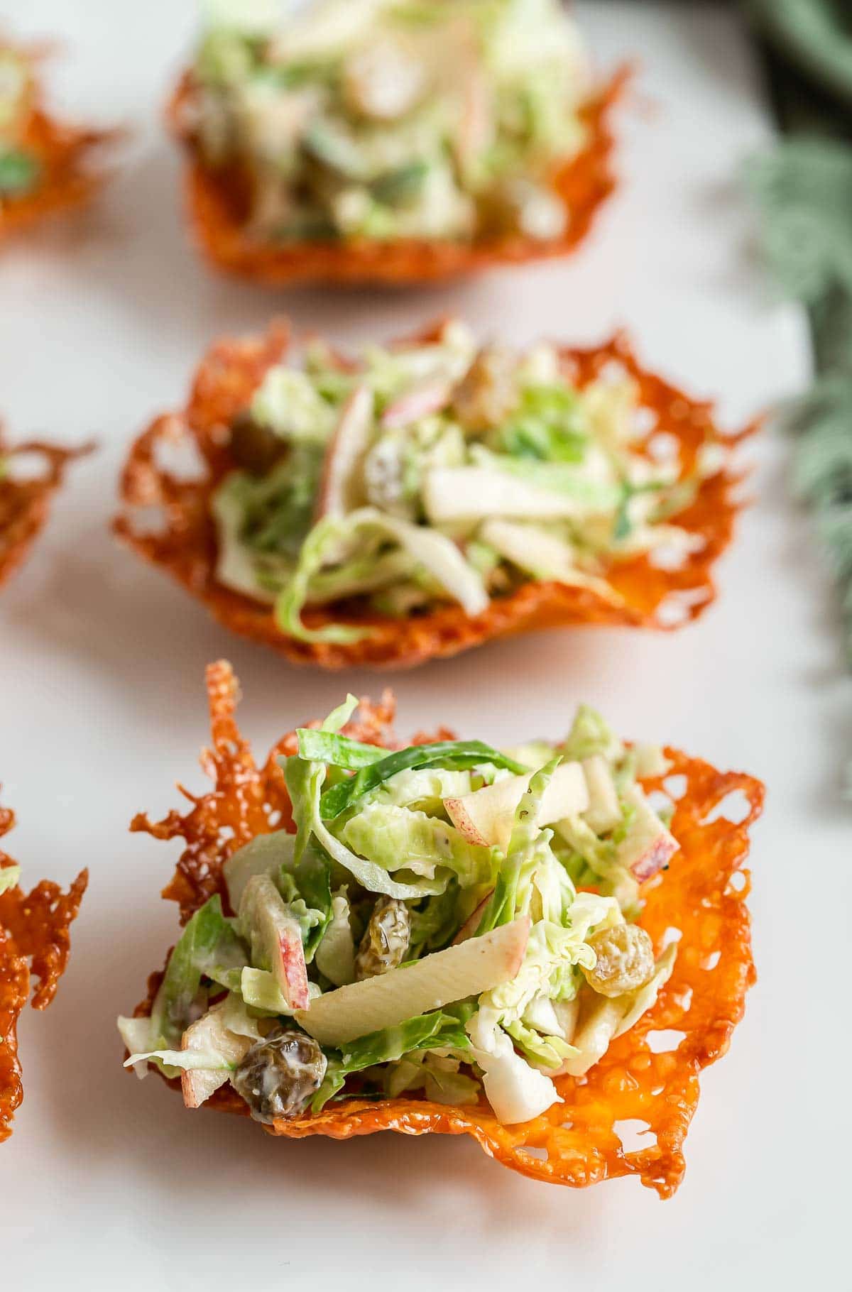 Brussels sprout slaw scooped into cheese cups.