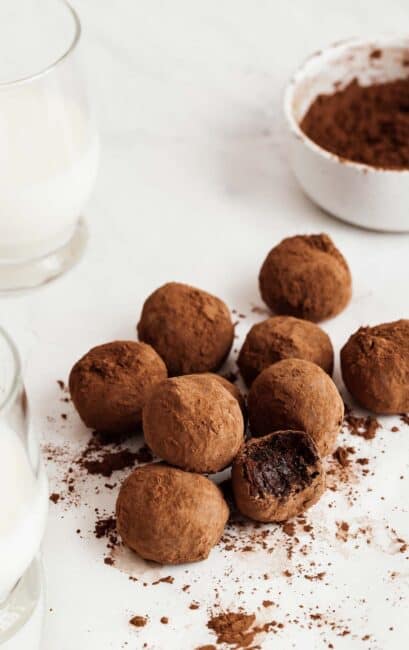 Pile of healthy chocolate truffles with bite missing from one.