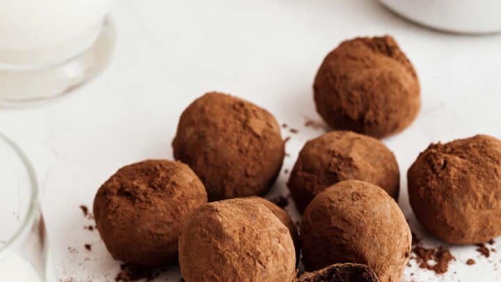 Pile of healthy chocolate truffles with bite missing from one.