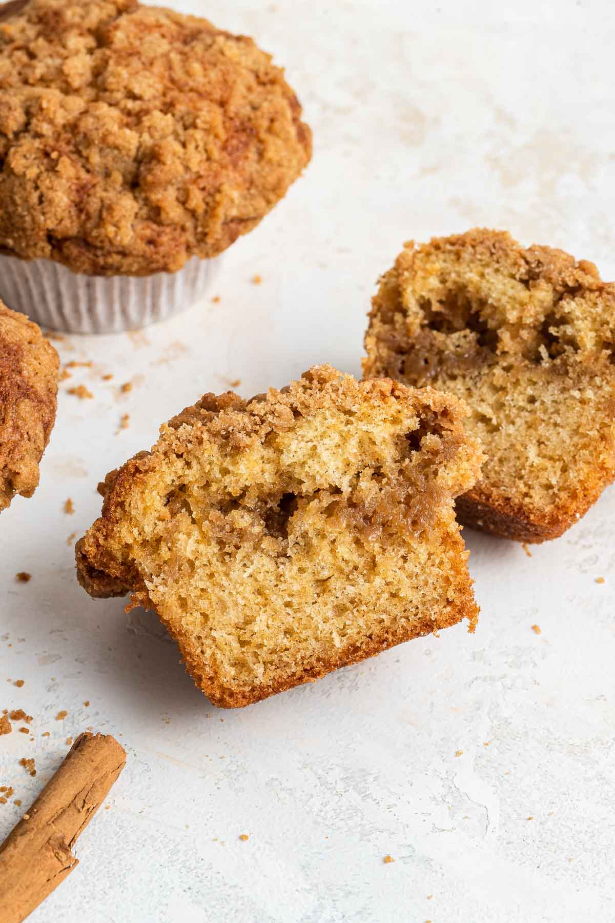 Coffee cake muffin sliced in half to show inner streusel filling.
