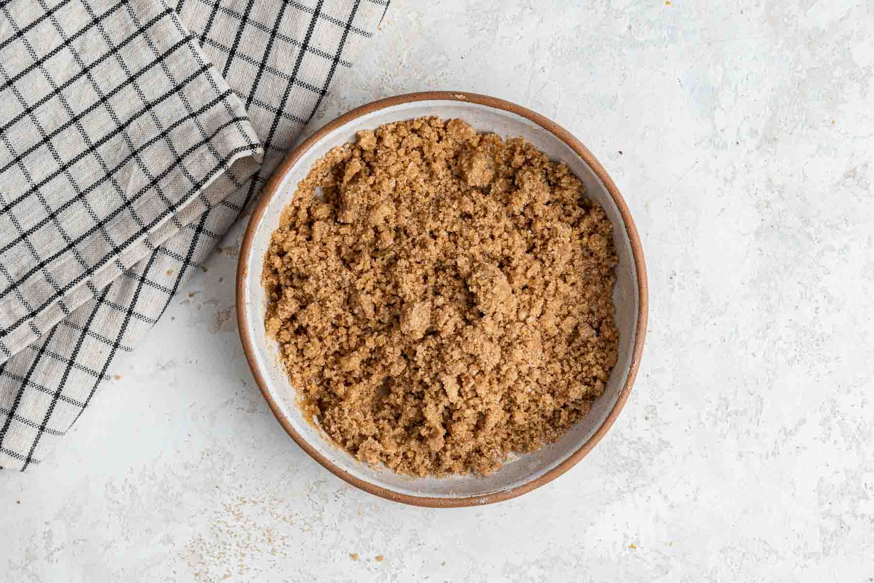 Bowl of crumb topping for coffee cake muffins.