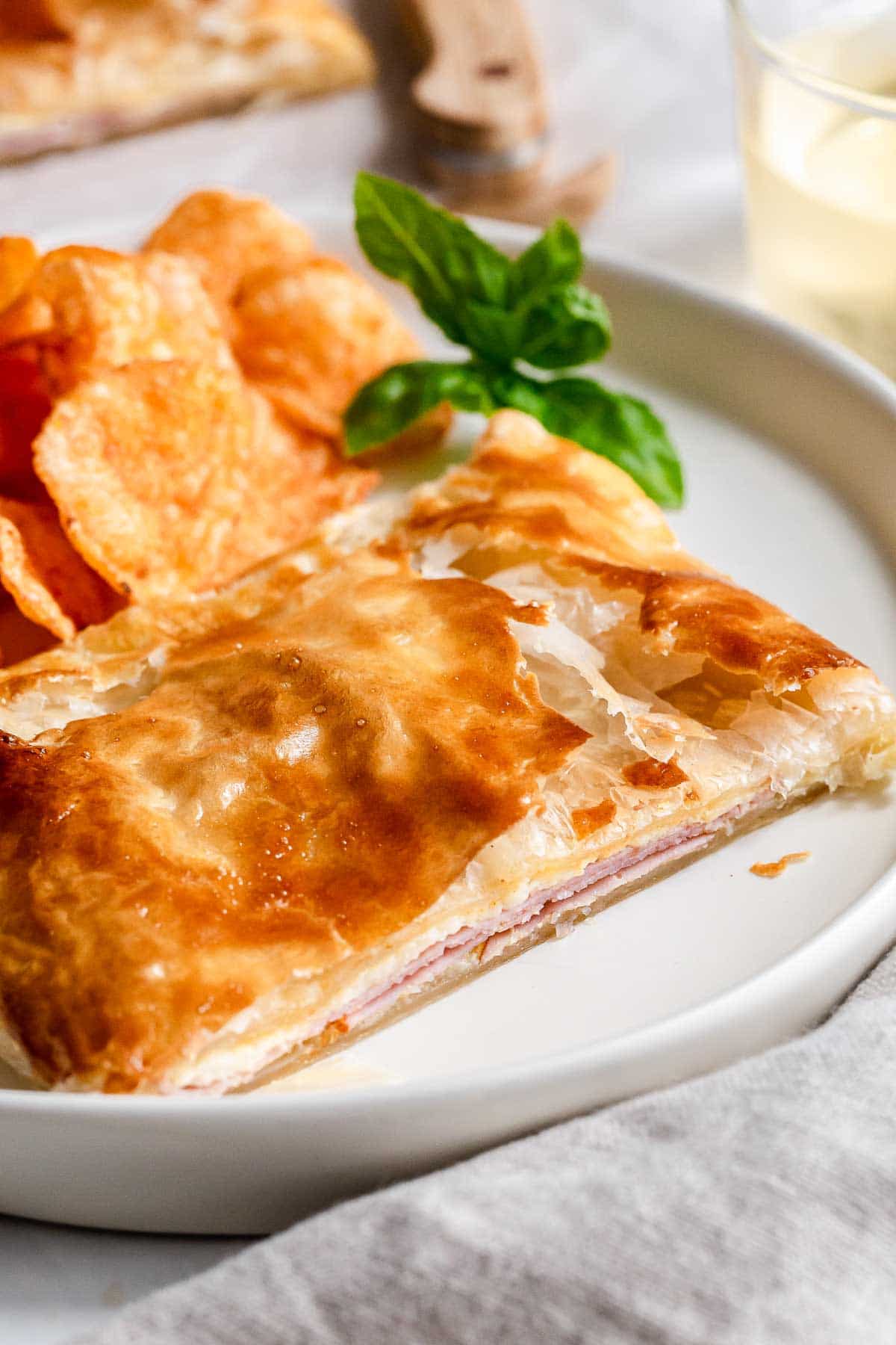 Ham and cheese pastry on plate.