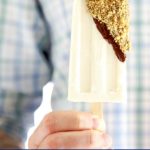 Cheesecake Popsicles dunked in chocolate and rolled in crushed graham crackers
