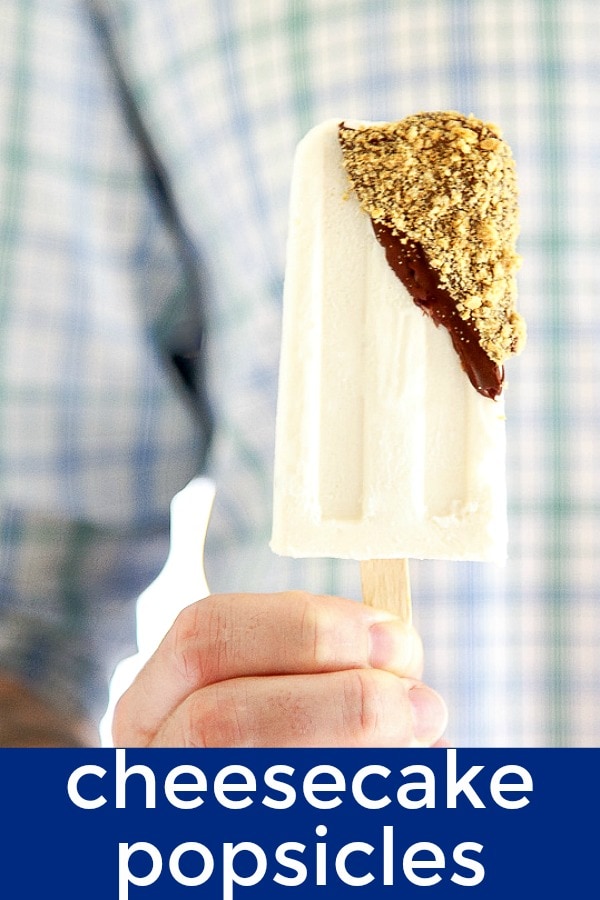 Cheesecake popsicles dunked in melted chocolate magic shell and rolled in crushed graham cracker crumbs. Customize and add cherries for a cherry cheesecake popsicle! #cheesecake #popsicles #icepops #frozendessert #cheesecakepopsicle