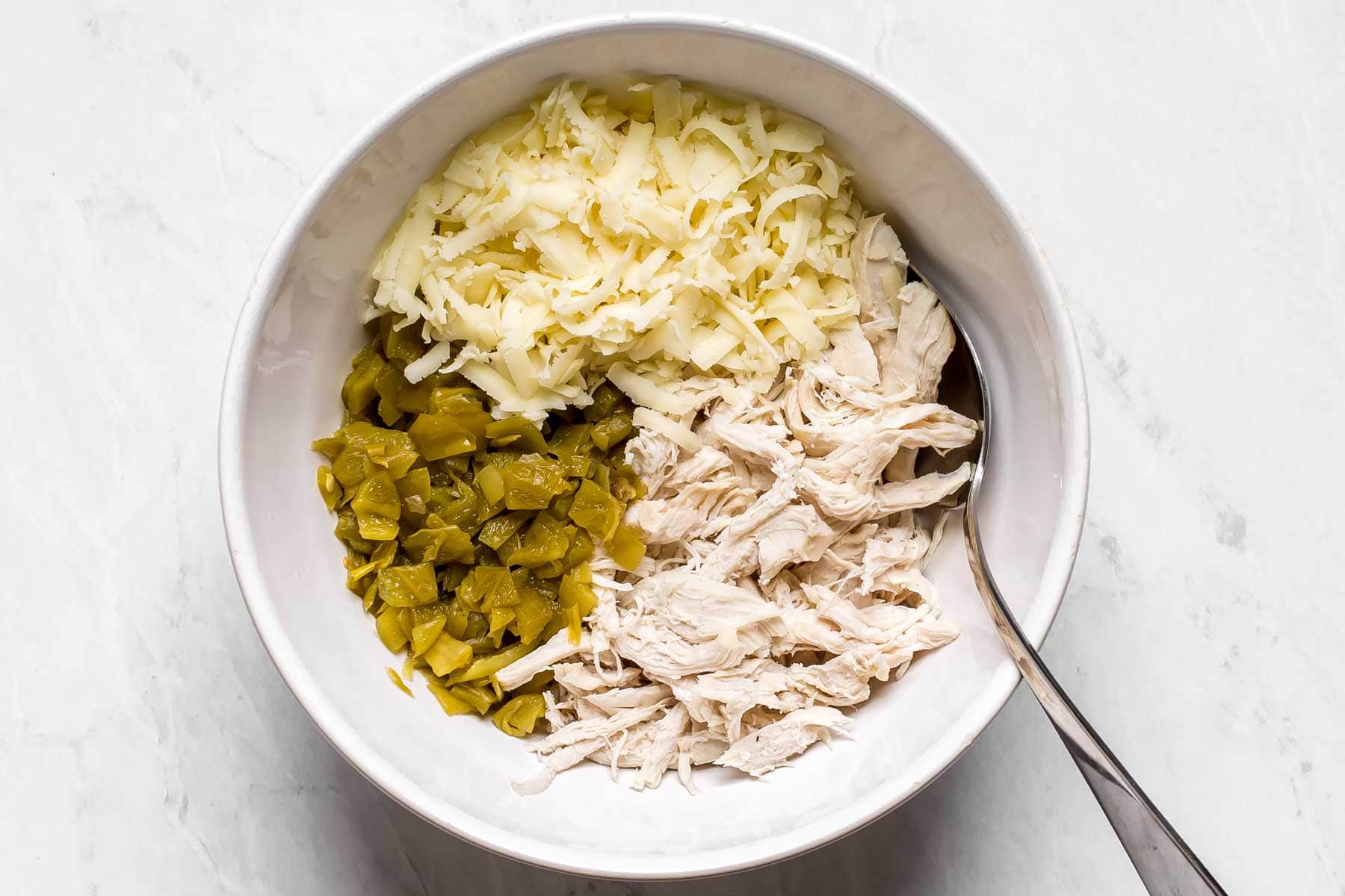 Bowl with chicken, cheese and green chiles.