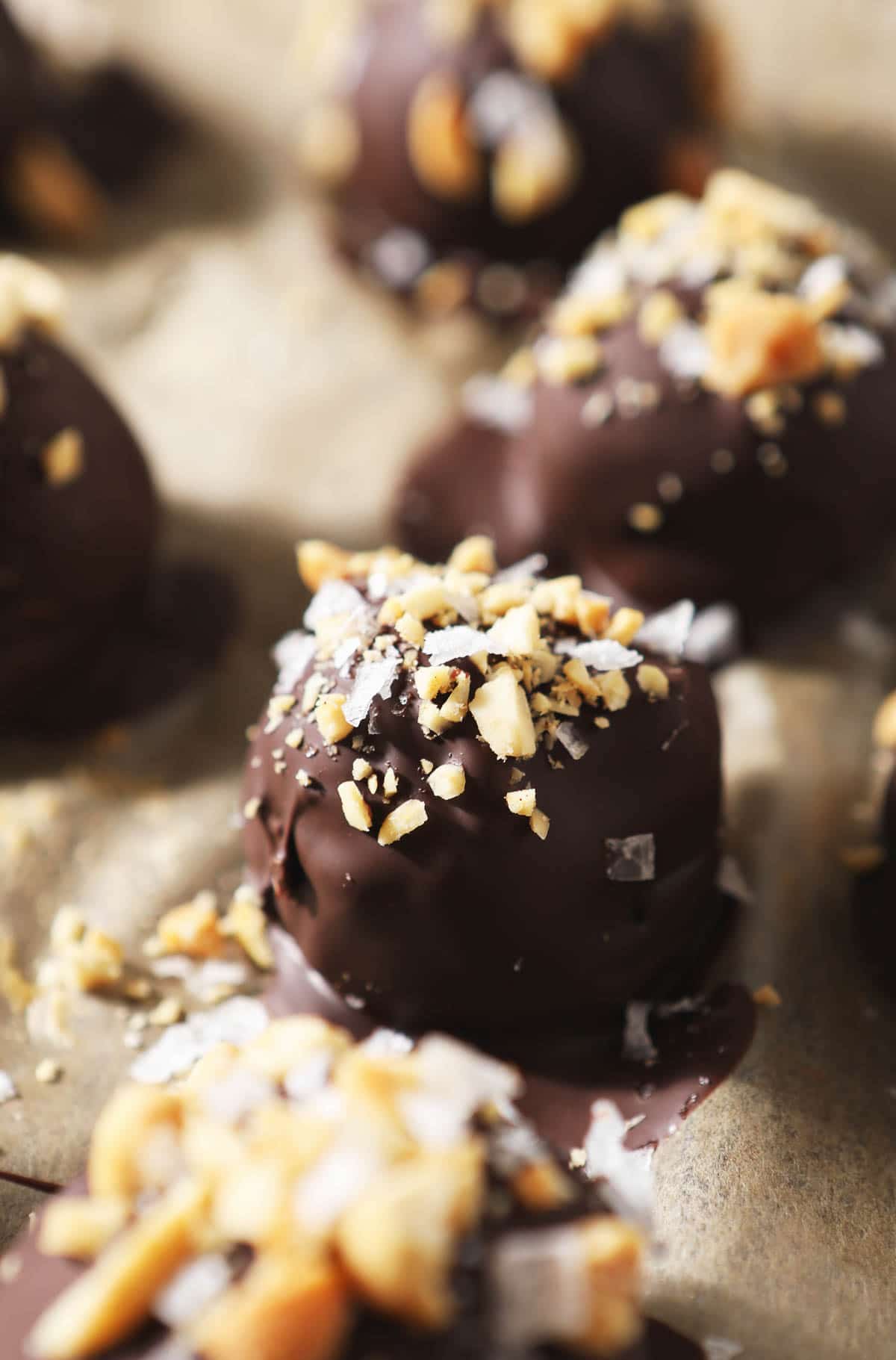 Close up of chocolate truffles on parchment paper.