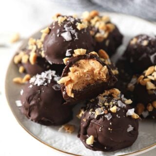 Plate of peanut butter truffles dipped in chocolate.