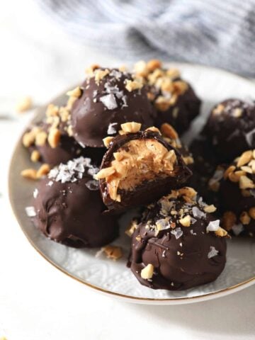 Plate of peanut butter truffles dipped in chocolate.