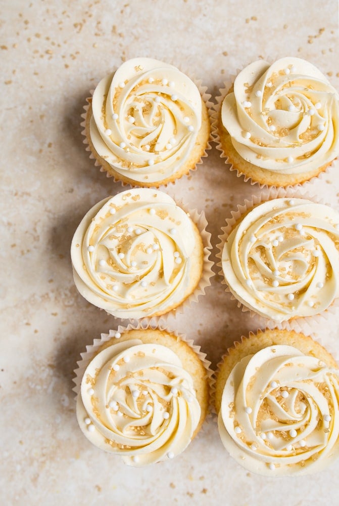 Almond wedding cake cupcakes with perfect white buttercream roses.