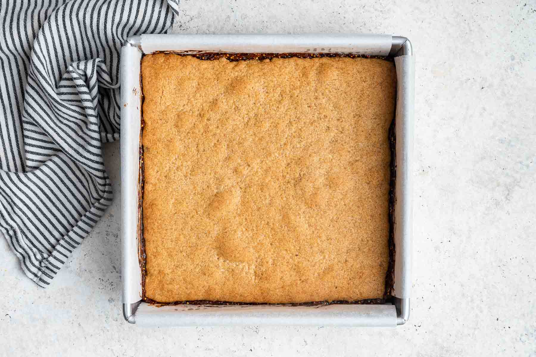 Square pan with golden brown crust baked inside.