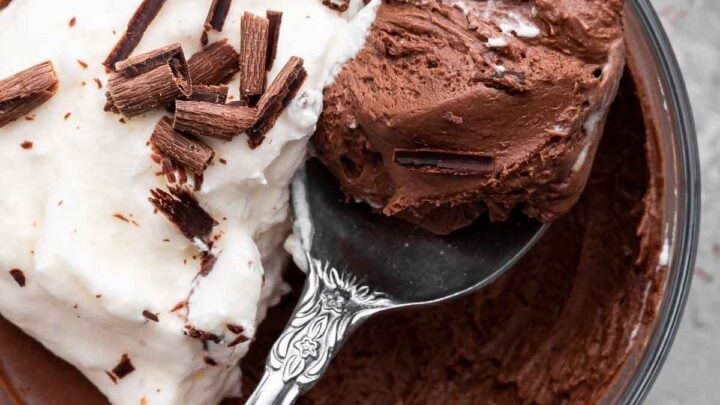 Super close shot of chocolate mousse with spoon removing a bite.