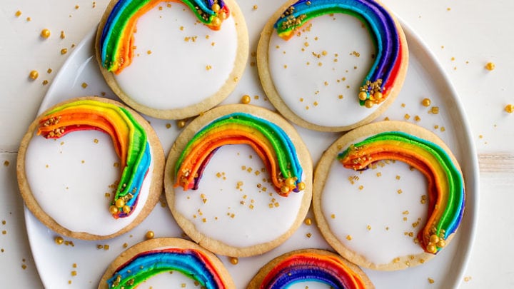 Rainbow Cookies with rainbow swirl buttercream frosting and a white Royal Icing base