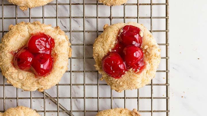 Cherry Cheesecake Cookies: cheesecake cookies rolled in graham cracker crumbs and topped with canned pie cherries.