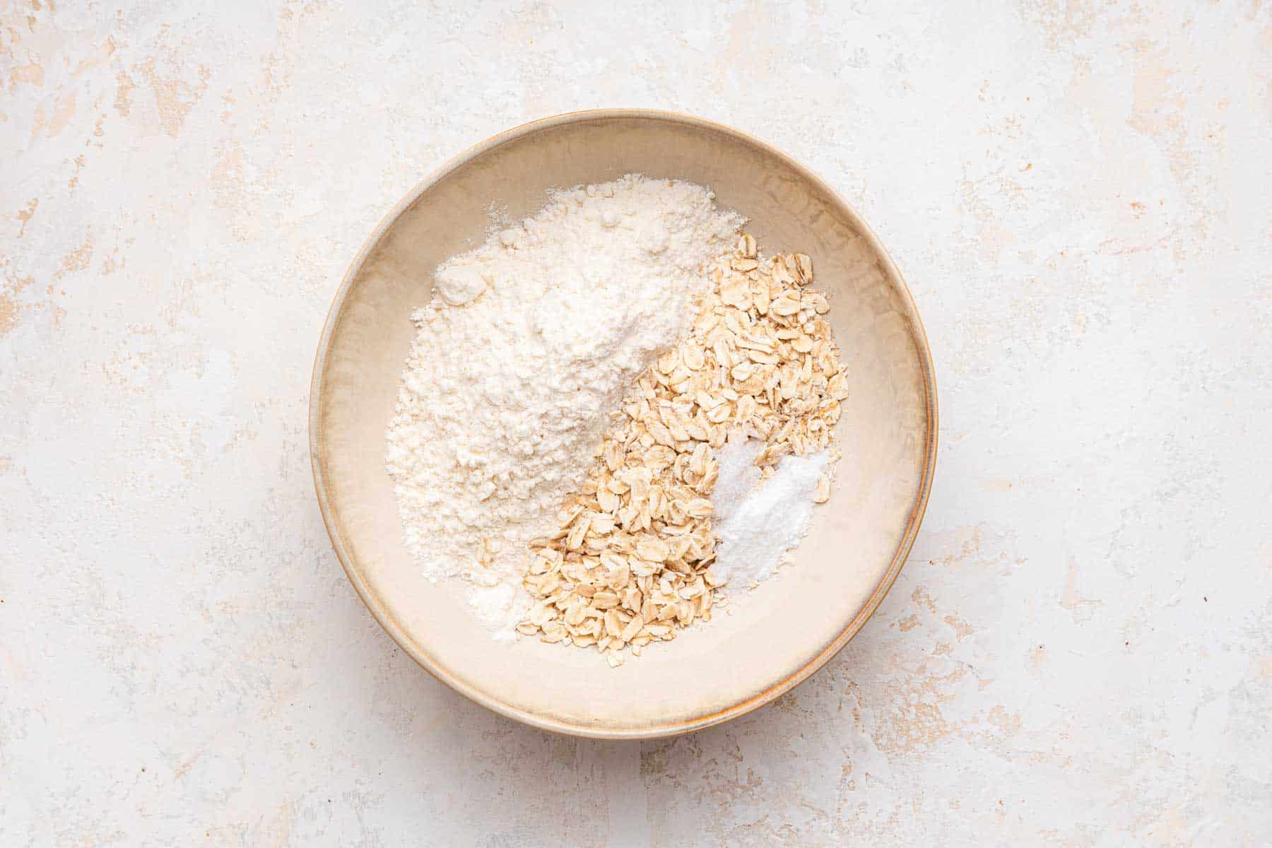 Small plate with flour, oats and baking soda.