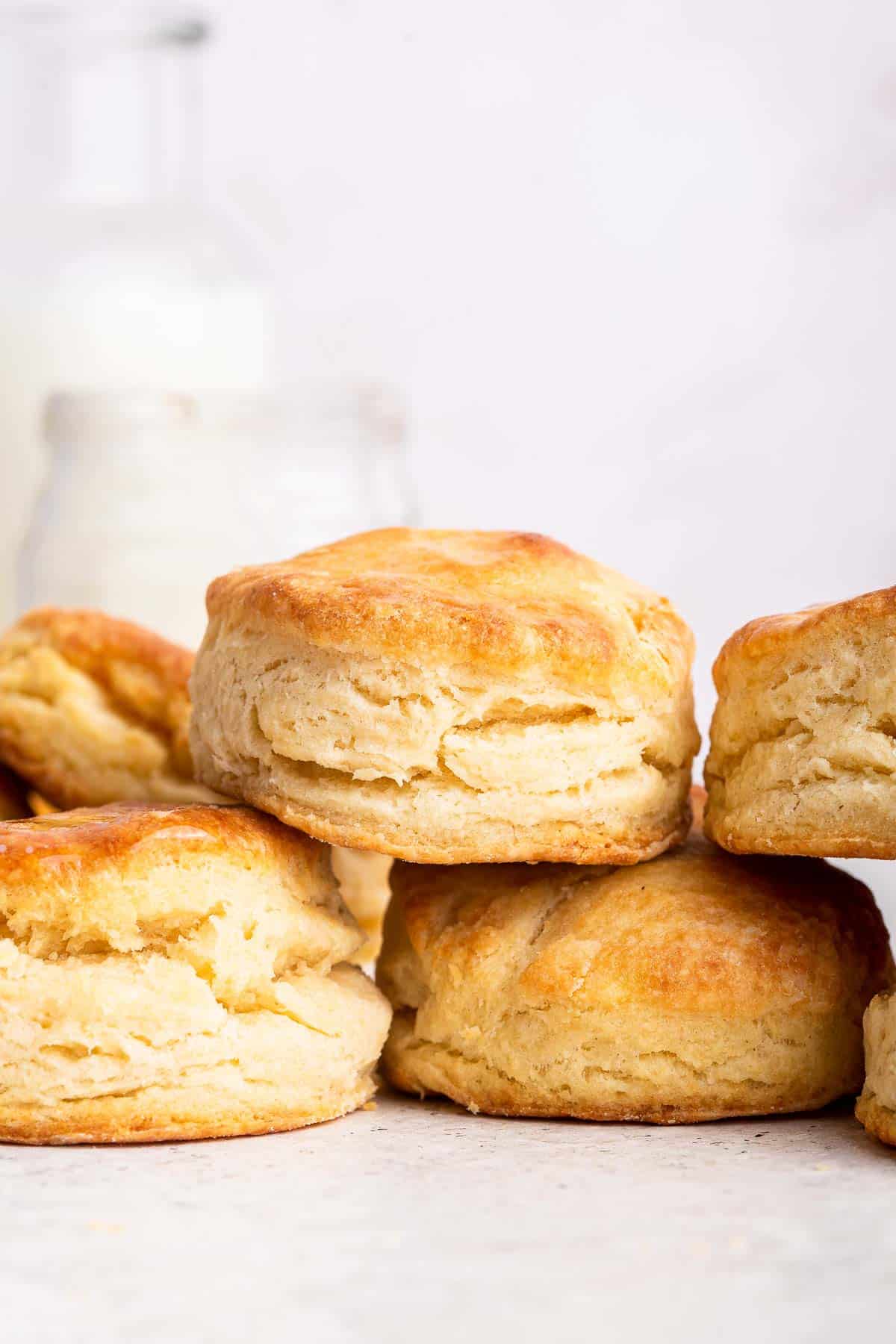 Vertical shot of homemade buttermilk biscuits stacked on top of each other.
