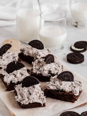 Tray with frosted oreo brownies and half oreos on top.