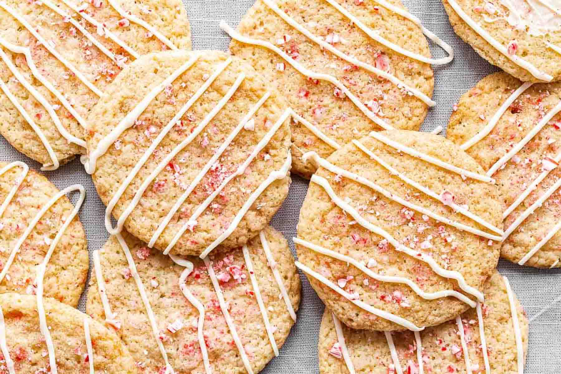 Candy cane sugar cookies drizzled with white chocolate and crushed peppermints.
