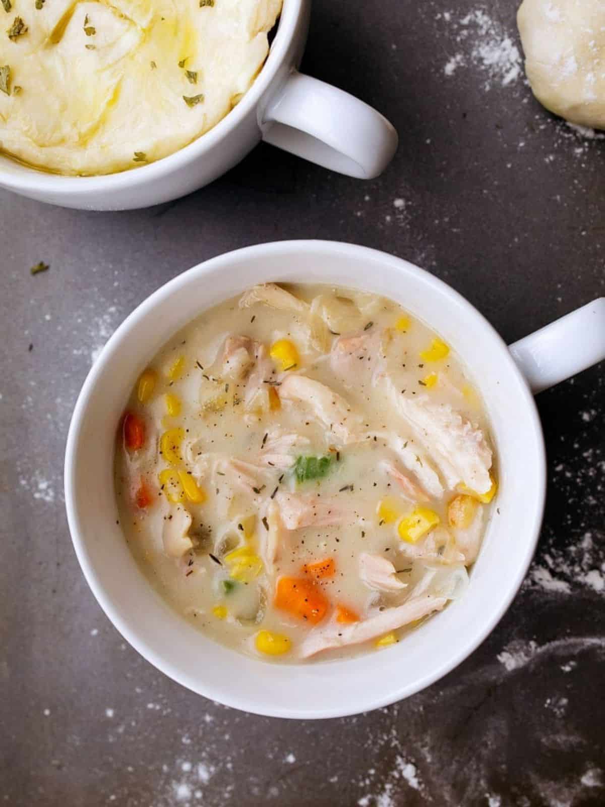 White soup mug filled with chicken pot pie with no crust.