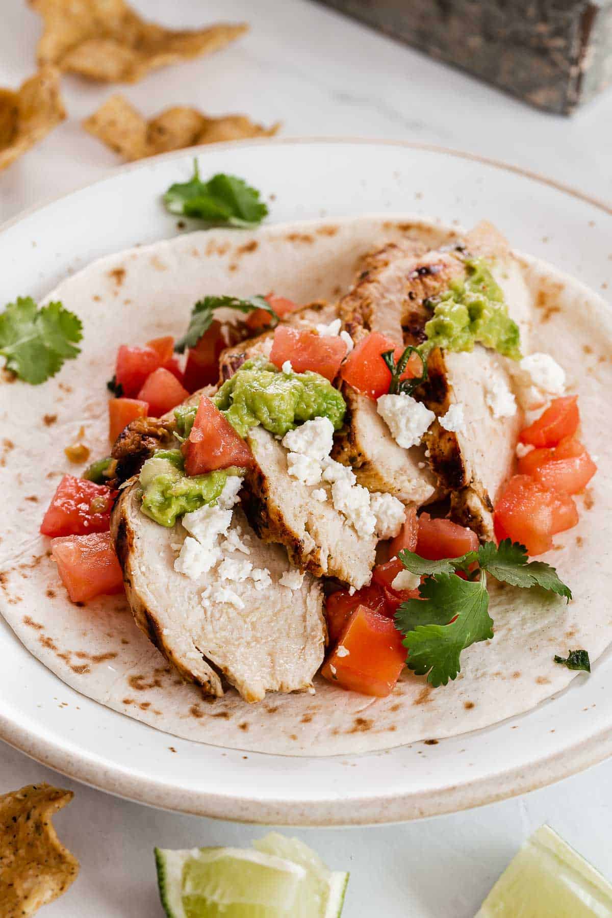 Close up of cilantro lime chicken in a tortilla.