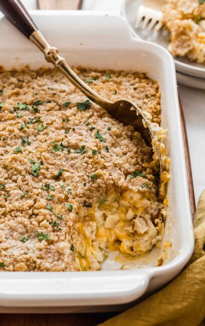 Casserole dish with baked chicken and crunchy topping.