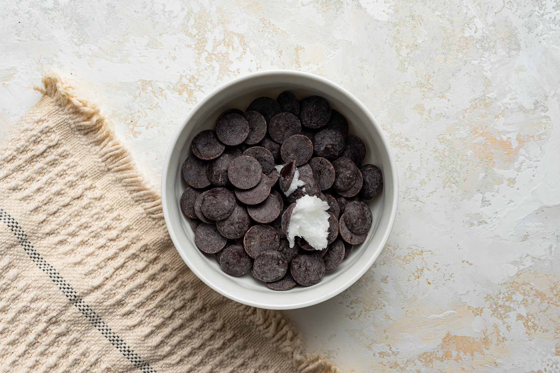 Chocolate chips and coconut oil in small bowl.