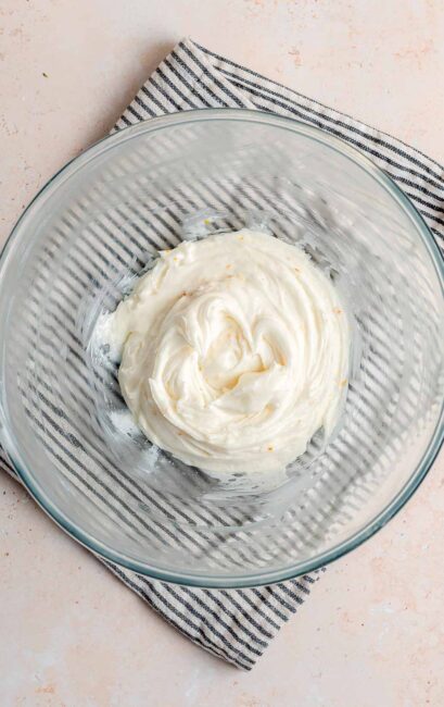 Ricotta frosting in a clear glass bowl.