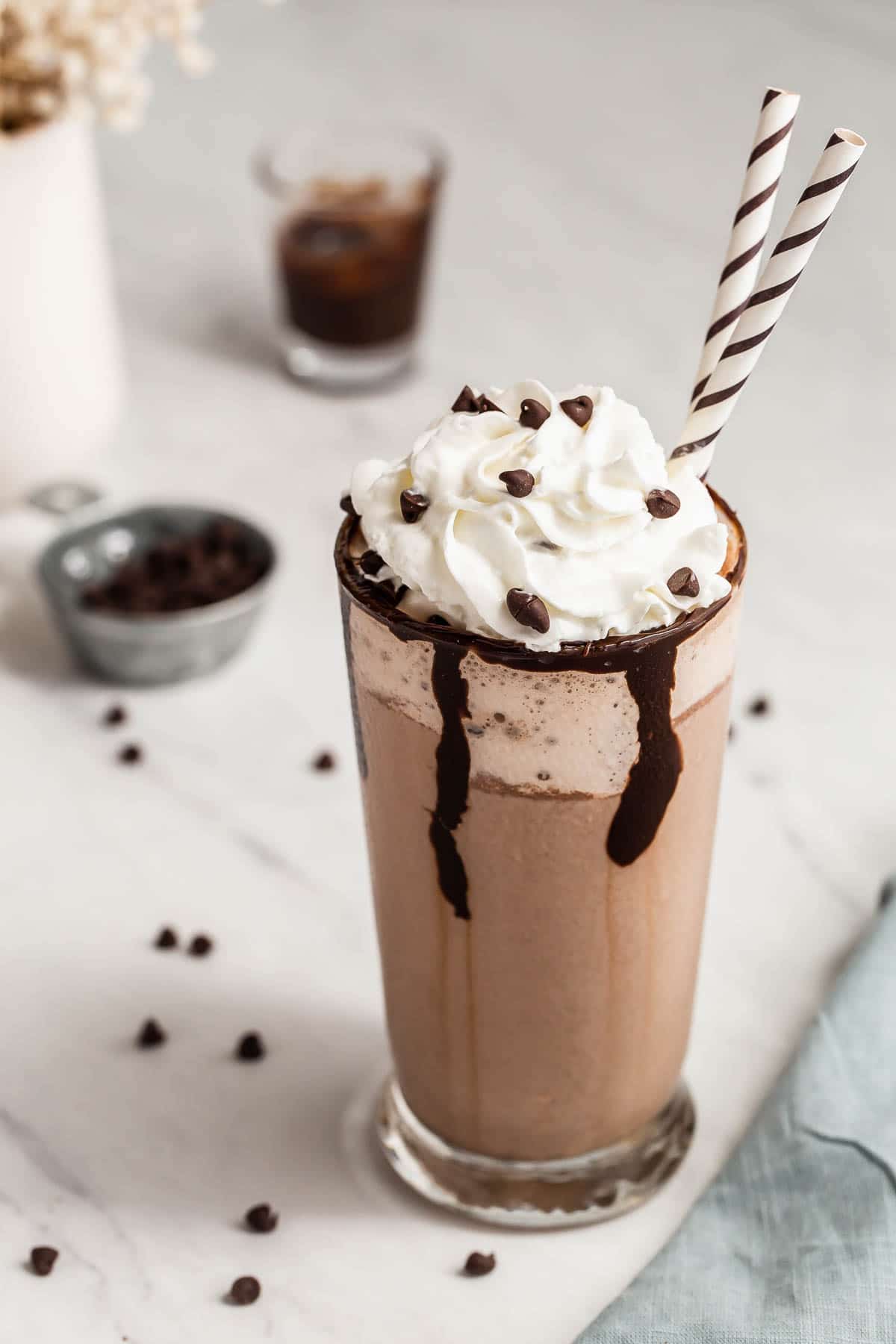 Starbucks double chocolate chip frappuccino in a glass with straw.