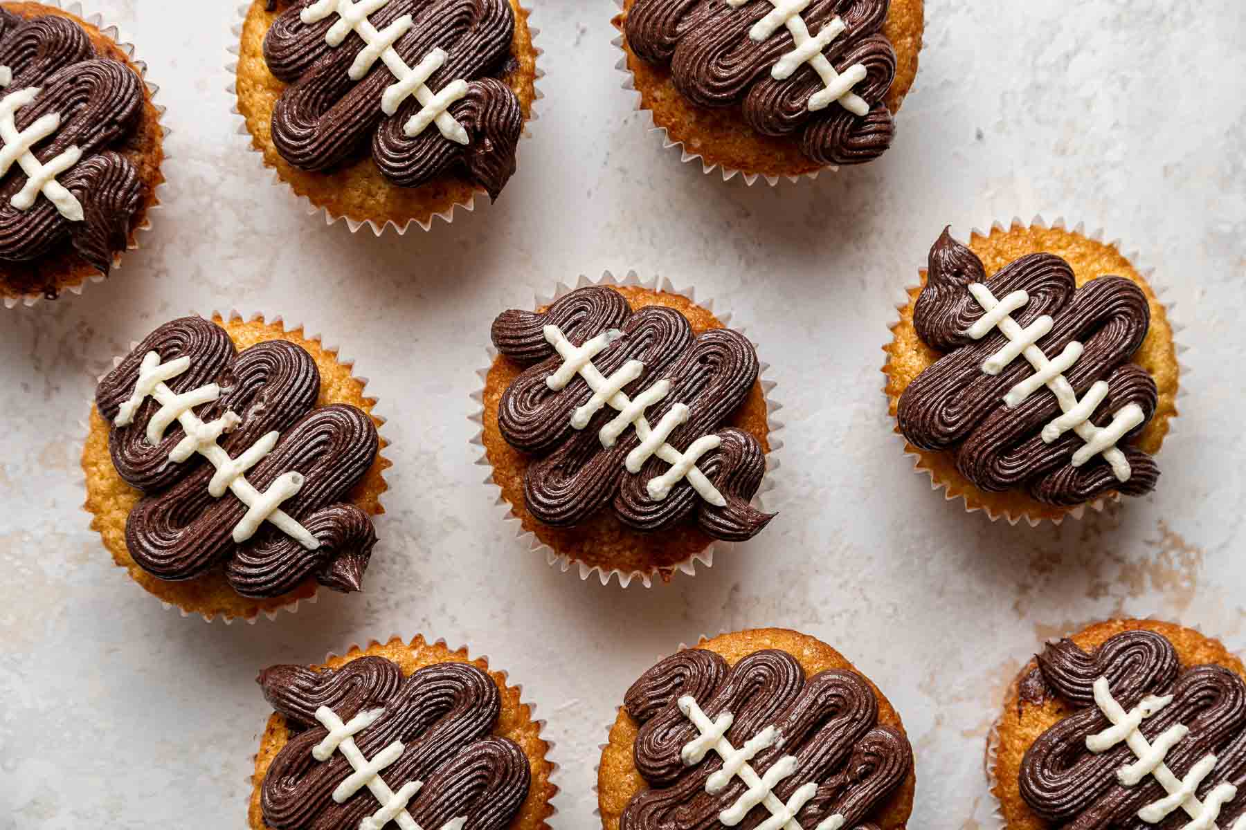 Cupcakes with footballs piped on top.