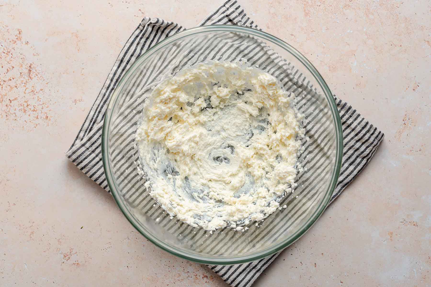 Beat butter and ricotta in a bowl.