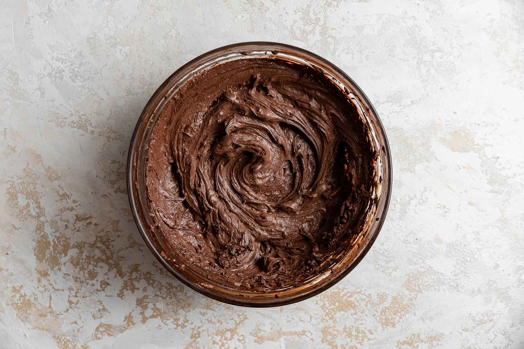 Bowl of chocolate buttercream frosting.